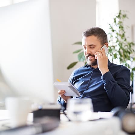 Man in an office talking on the phone
